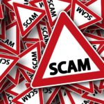 Signs with the word "scam" on each