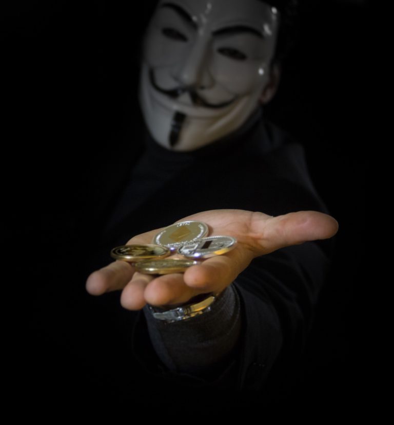 'anonymous" character holding bitcoins in hand