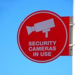 Sign showing a camera and the words "Security Cameras in Use"