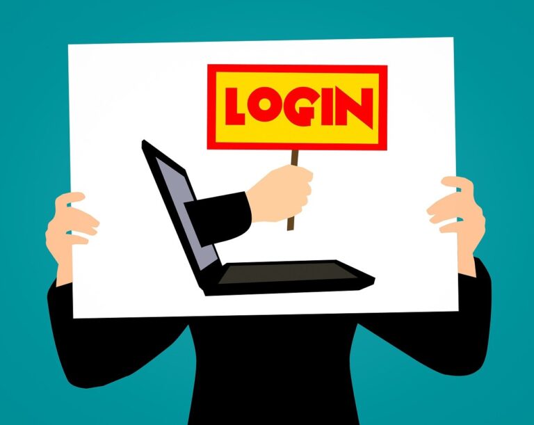 Person holding a sign with a picture of a laptop and a hand coming out of the screen that is holding a sign that says "login"