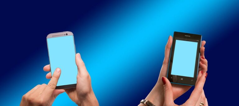 two people texting with cell phones